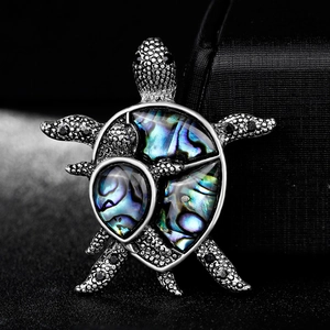 Artistic silver turtle brooch set with colorful abalone shell and dark gemstones