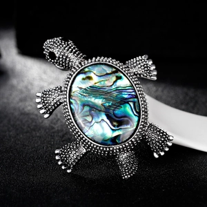 Vintage silver turtle brooch with colorful abalone shell inlay and detailed metal texture