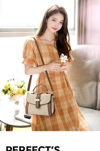 Close-up of beige crossbody bag with cross pattern, brown leather trim and metal lock