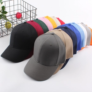 Stack of colorful cotton baseball caps in various solid colors for men and women