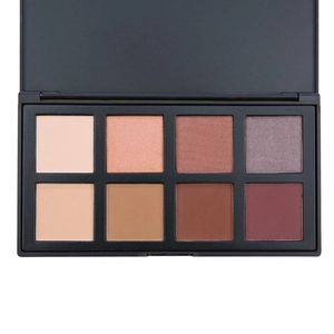 Macro detail of 8-color matte and shimmer eyeshadow palette with warm earthy tones