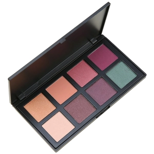 Macro view of 8-color eyeshadow palette showing matte and shimmer textures in black case
