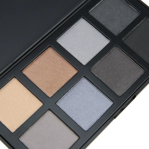 Close-up of 8-color matte eyeshadow palette showing brown, gray, and blue powder textures