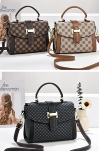 Detail of vintage tote bag with gold metal buckle and detachable crossbody strap