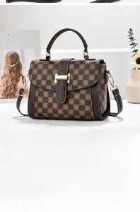 Detail of checkered tote bag with gold metal buckle and detachable shoulder strap