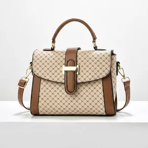 Detailed view of vintage diamond lattice handbag with brown leather trim and golden buckle