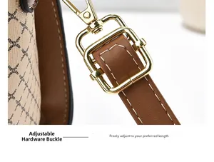 Detail of golden metal buckle and brown lychee grain leather strap with white stitching