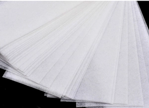 Detail of disposable non-woven hair removal wax strips with visible fiber texture