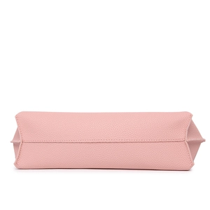 Close-up of pink litchi grain PU leather handbag base with reinforced stitching