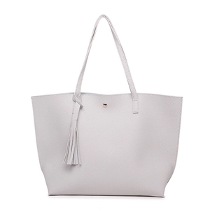 Detail of light grey lychee texture tote bag with tassel charm and magnetic closure