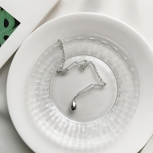 Detailed view of a minimalist S925 silver water drop pendant on a fine adjustable chain