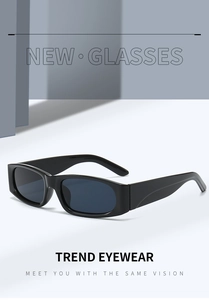 Close-up of black rectangular sunglasses with dark UV-protective lenses and high-gloss finish