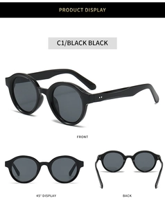 Detail view of oval black sunglasses featuring metal rivets and UV protection frames