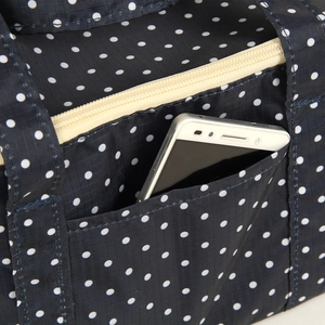 Navy blue polka dot Oxford fabric thermal lunch bag with spacious front storage pocket
