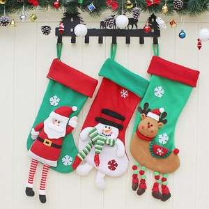 Three Christmas stockings with Santa, Snowman, and Reindeer hanging on a rack
