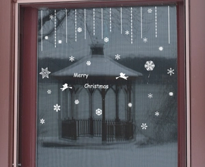 White Christmas window decals with snowflakes and Merry Christmas text on glass