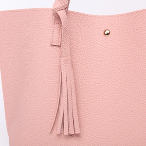 Close-up of pink litchi grain PU leather tote bag featuring a decorative tassel and gold stud