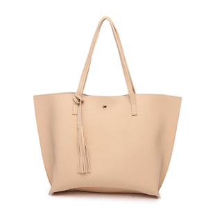 Detailed macro shot of beige pebble leather texture and fringe tassel on the tote bag