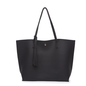 Close-up of black lychee grain faux leather texture with tassel and gold magnetic buckle