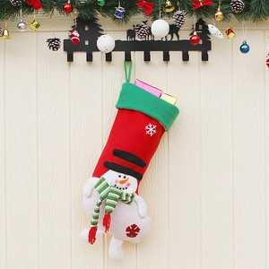Christmas stocking with 3D snowman and snowflakes hanging on a decorated wall decor