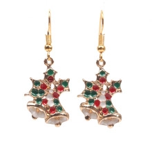 Detail of Christmas bell earrings with red and green enamel on a golden base