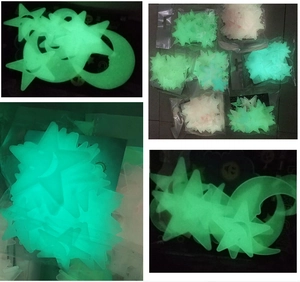 Detailed view of 3cm glow in the dark plastic stars and moon stickers in green fluorescent