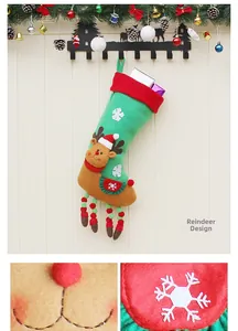 Detail of a Christmas stocking with reindeer design and white snowflake embroidery