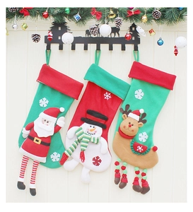 Three festive Christmas stockings with 3D Santa, Snowman and Reindeer on wood wall