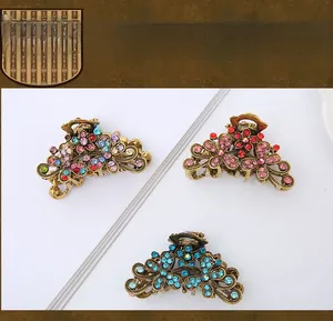 Detailed view of three vintage alloy hair claws with colorful floral crystal inlay