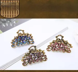 Detail view of three vintage-style alloy hair claws with colorful sparkling rhinestones