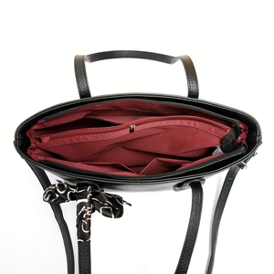 Black tote bag with spacious interior compartments and decorative printed silk scarf handle
