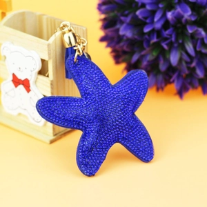 Detail of blue starfish bag charm with sparkling rhinestones and matching tassel