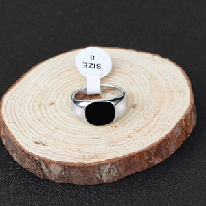 Detail of silver stainless steel signet ring with black rectangular inlay and size 8 tag