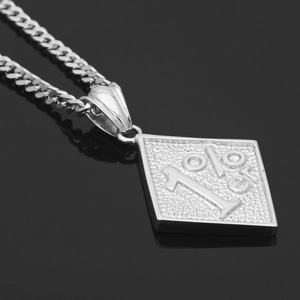 Macro detail of 1%er engraved rhombic alloy pendant with high-shine cuban chain texture