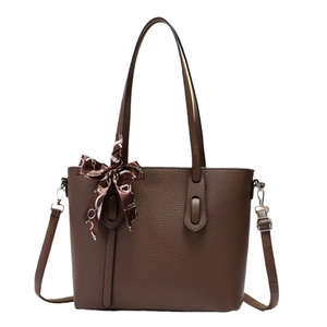 Brown litchi grain leather tote bag with elegant silk scarf and simple minimalist design