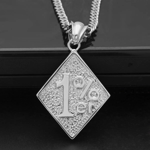 Macro shot of silver 1%er diamond pendant with textured finish and curb chain