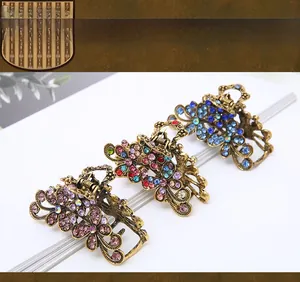 Detailed view of three vintage flower hair claws with colorful rhinestones on bronze alloy