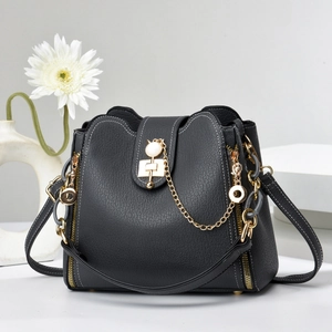 Vue détaillée du sac à main en cuir noir avec des chaînes et des finitions métalliques dorées