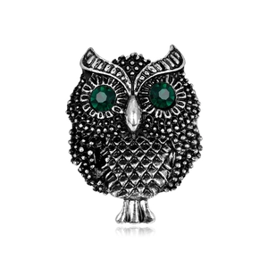 Vintage silver owl brooch with green crystal eyes and detailed textured alloy feathers