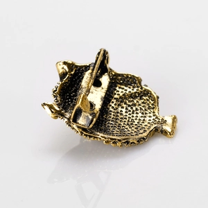 Vintage gold owl brooch in alloy with crystal detail and pin closure on white background