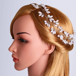 Detail of handmade bridal headband featuring silver wire weaving and white pearls