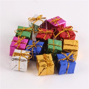 Close-up of mini colorful laser foam gift boxes with golden bows for Christmas tree decoration