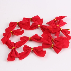 Macro view of small red velvet Christmas bows with gold twist ties for tree decoration