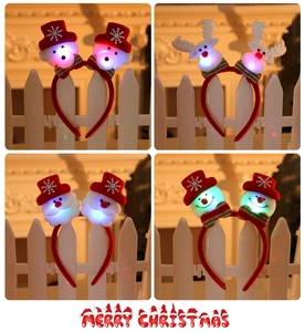 Detail view of four LED Christmas headbands featuring bear, reindeer, Santa, and snowman
