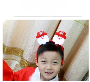 Toddler boy wearing a Christmas headband with cute 3D plush Santa Claus ornaments