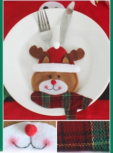 Detail of reindeer cutlery holder with red scarf for Christmas table decoration