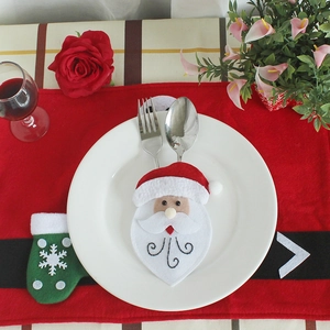 Christmas Santa cutlery holder and red placemat set for festive dining table decoration