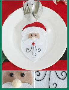 Detailed view of handmade Santa Claus cutlery holder with festive red felt and sewing