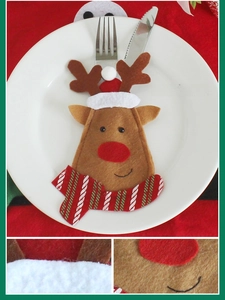 Detail of Christmas reindeer cutlery holder featuring a red hat and striped scarf