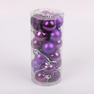 Detail of purple Christmas balls with matte, glossy, and glitter textures in a clear tube